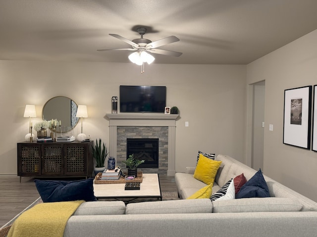 7101 22nd St, Lubbock, TX 79407 - living room featuring wood finished floors, a ceiling fan, a fireplace, and baseboards
