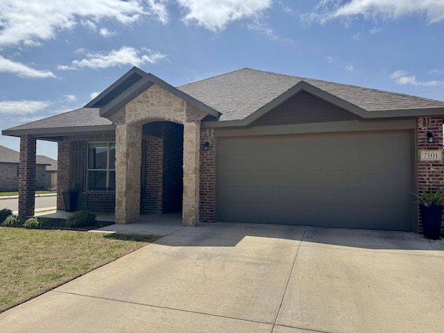 7101 22nd St, Lubbock, TX 79407 - view of front facade featuring brick siding, concrete driveway, a garage, roof with shingles, and a front yard