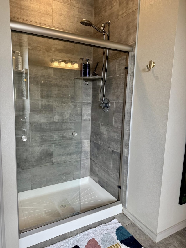 7101 22nd St, Lubbock, TX 79407 - bathroom with a shower stall and baseboards