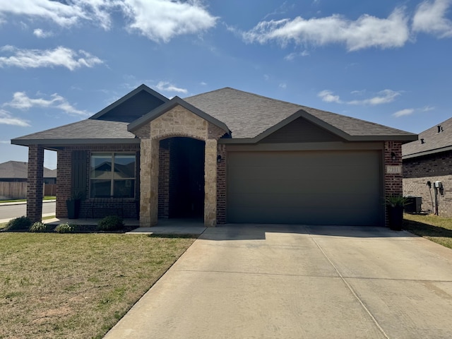7101 22nd St, Lubbock, TX 79407 - view of front facade with brick siding, concrete driveway, a garage, a front lawn, and roof with shingles
