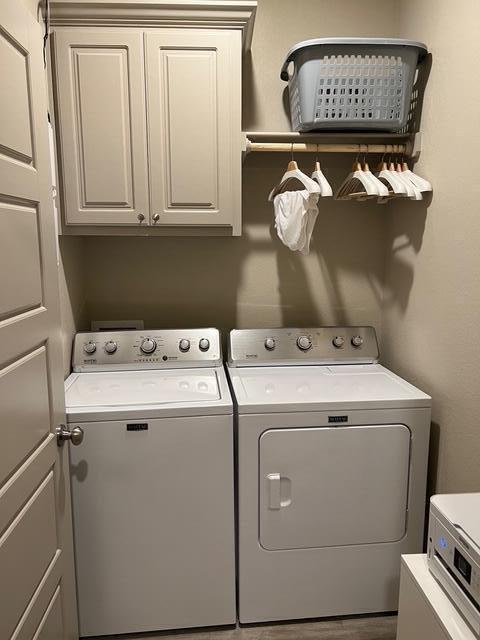 7101 22nd St, Lubbock, TX 79407 - washroom with washer and clothes dryer and cabinet space