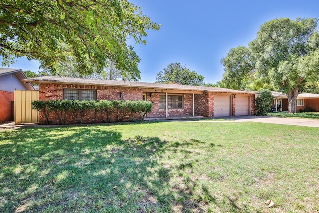 ranch-style house with a garage and a front lawn