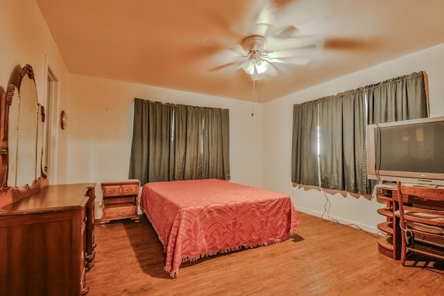 bedroom with hardwood / wood-style flooring and ceiling fan