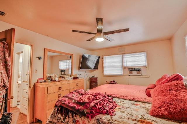 bedroom with multiple windows, cooling unit, light hardwood / wood-style flooring, and ceiling fan