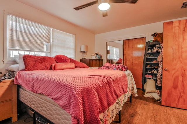 bedroom featuring hardwood / wood-style flooring, a closet, and ceiling fan