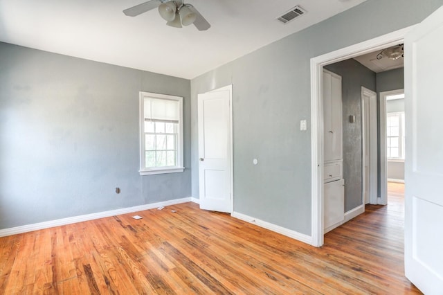 unfurnished room featuring ceiling fan, plenty of natural light, and hardwood / wood-style floors