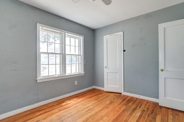 unfurnished room featuring ceiling fan and light hardwood / wood-style flooring