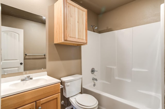 full bathroom featuring washtub / shower combination, vanity, and toilet