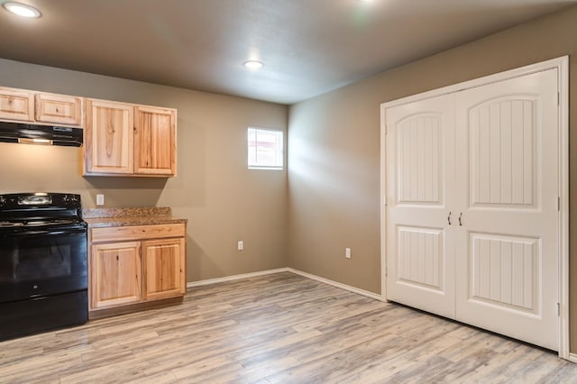 kitchen featuring black / electric stove, light brown cabinetry, and light wood-type flooring