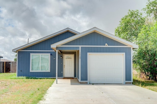 view of front of property featuring a garage and a front lawn