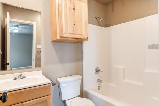 full bathroom with vanity, tub / shower combination, and toilet