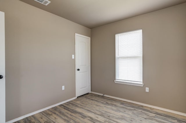 spare room featuring light hardwood / wood-style flooring