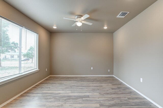 unfurnished room with ceiling fan and light hardwood / wood-style floors