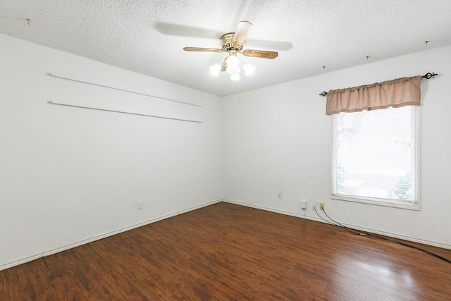 empty room with ceiling fan, hardwood / wood-style flooring, and a textured ceiling