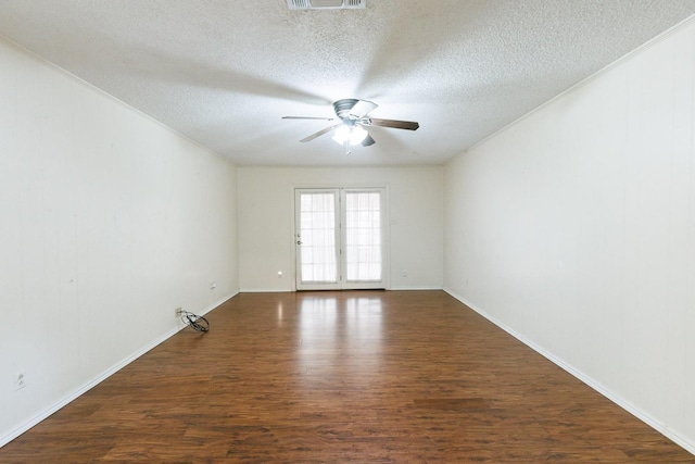 spare room featuring crown molding, ceiling fan, dark hardwood / wood-style floors, and a textured ceiling