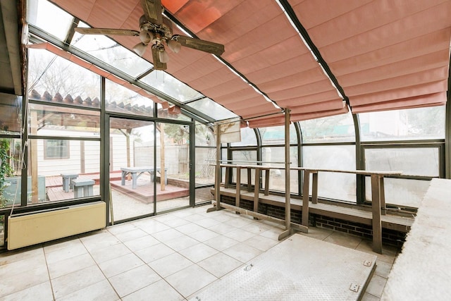 unfurnished sunroom featuring ceiling fan, plenty of natural light, and wooden ceiling