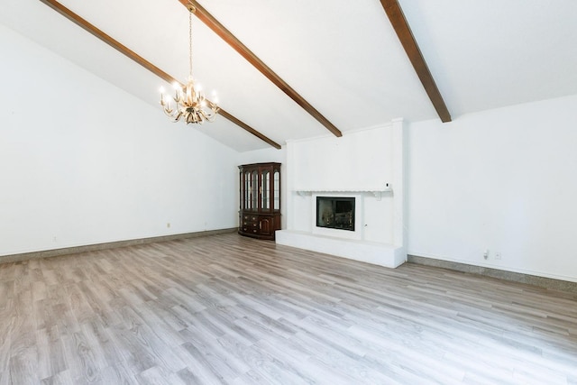 unfurnished living room featuring an inviting chandelier, beam ceiling, high vaulted ceiling, a fireplace, and light hardwood / wood-style floors