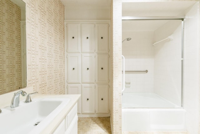 bathroom featuring tiled shower / bath and sink