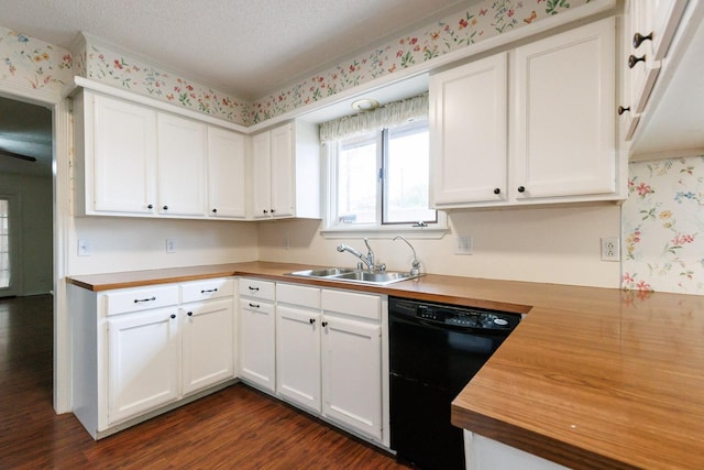 kitchen featuring butcher block counters, black dishwasher, sink, white cabinets, and a textured ceiling