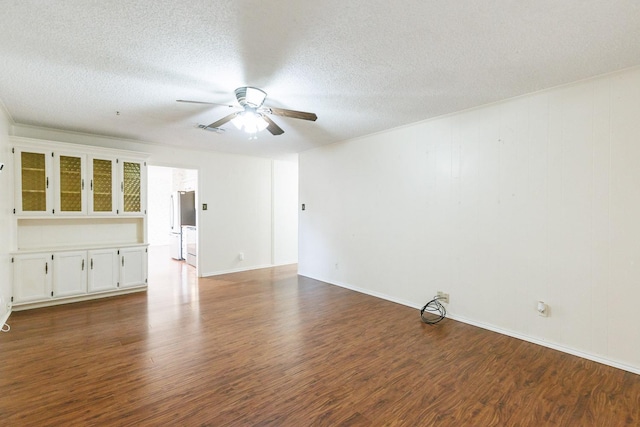 unfurnished living room with ceiling fan, dark hardwood / wood-style flooring, and a textured ceiling