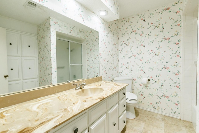 bathroom featuring vanity, toilet, and a shower