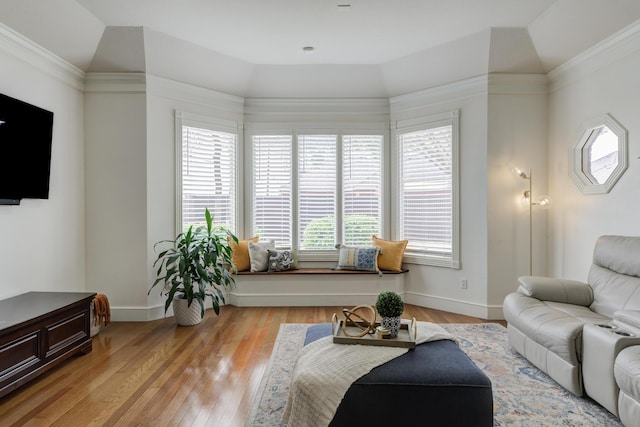 living area featuring baseboards and light wood-type flooring