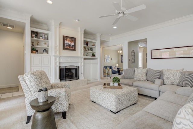 living room featuring recessed lighting, a high end fireplace, visible vents, a ceiling fan, and ornamental molding