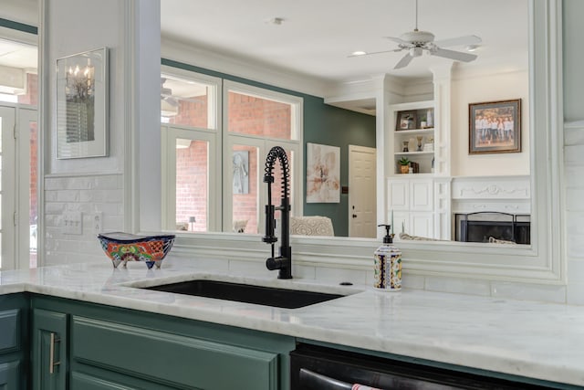 bar with a wealth of natural light, crown molding, a sink, and a fireplace