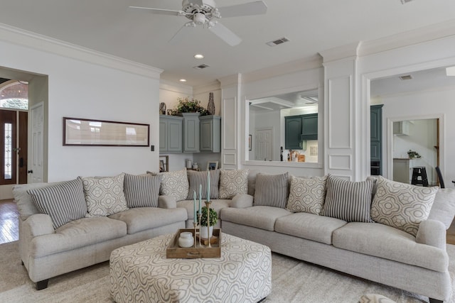 living area featuring a ceiling fan, visible vents, recessed lighting, and ornamental molding