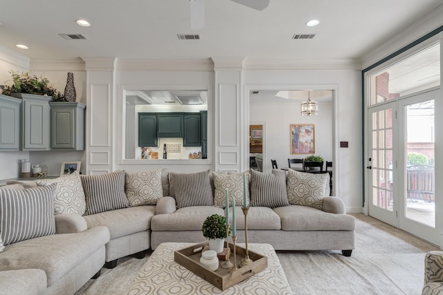 living room featuring visible vents and crown molding