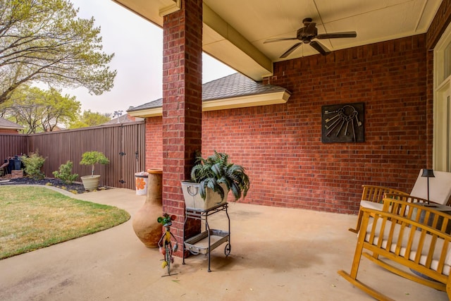 view of patio featuring fence and a ceiling fan
