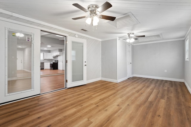 spare room featuring ornamental molding, light wood finished floors, ceiling fan, and baseboards