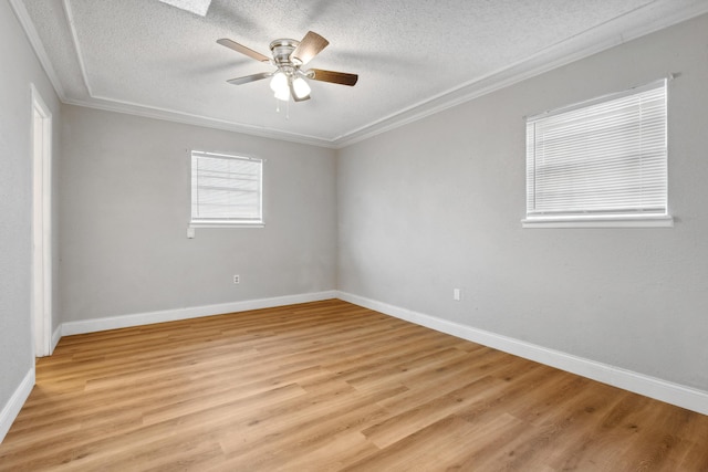 unfurnished room with a textured ceiling, ceiling fan, crown molding, and baseboards