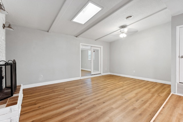 unfurnished living room with visible vents, a ceiling fan, light wood-style flooring, and baseboards