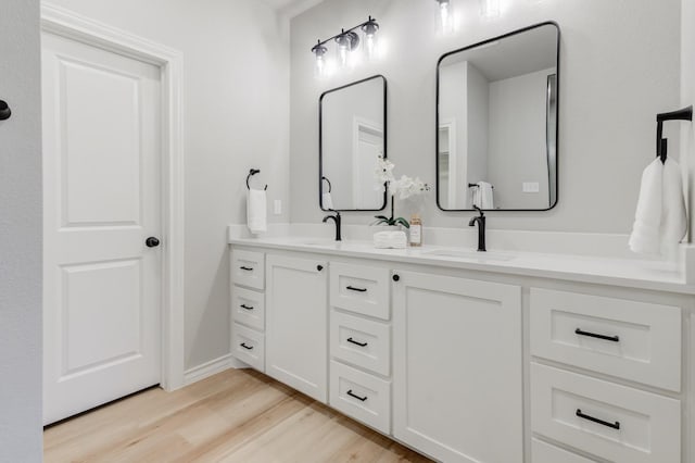 bathroom with hardwood / wood-style flooring and vanity