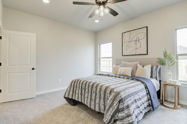 bedroom featuring light carpet and ceiling fan