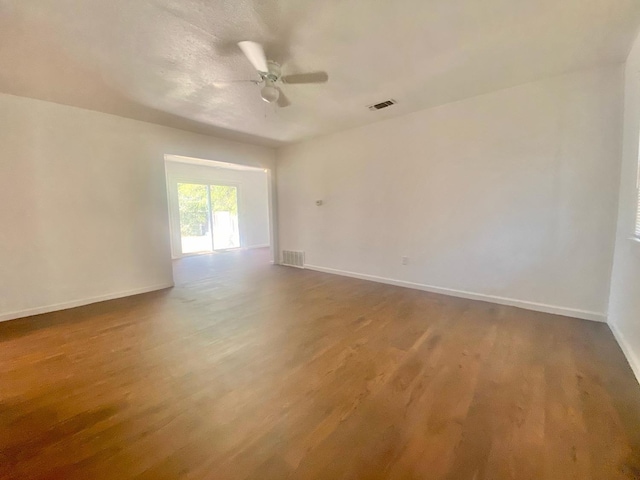 spare room featuring hardwood / wood-style floors and ceiling fan