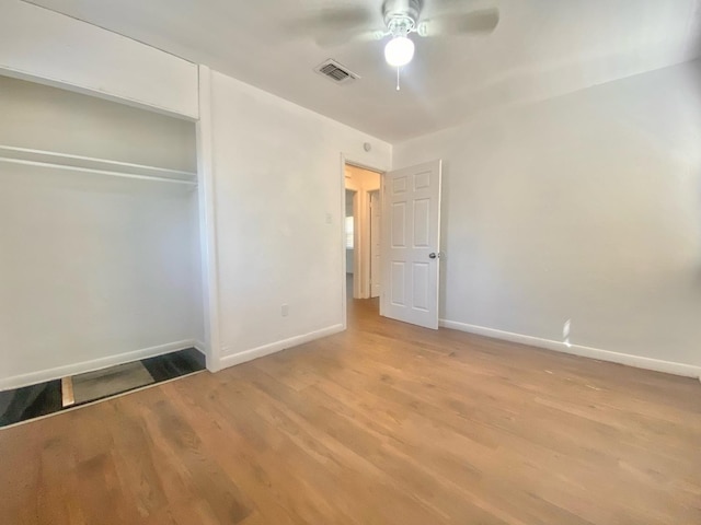 unfurnished bedroom featuring light hardwood / wood-style flooring, a closet, and ceiling fan