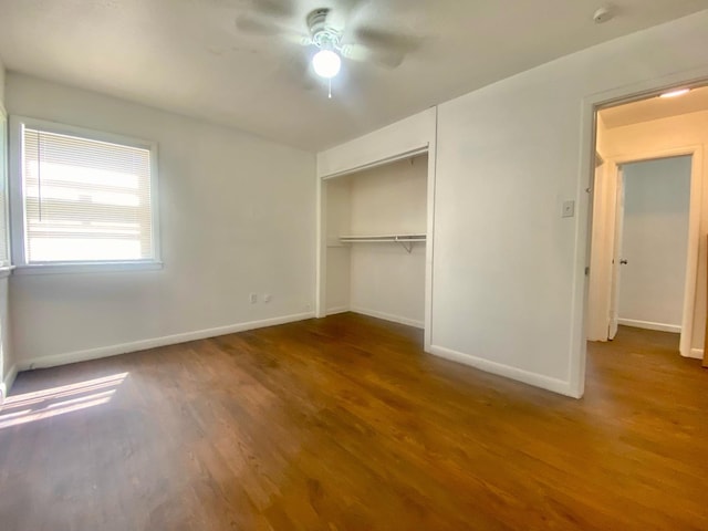 unfurnished bedroom featuring hardwood / wood-style flooring, ceiling fan, and a closet