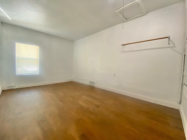 unfurnished room with hardwood / wood-style floors