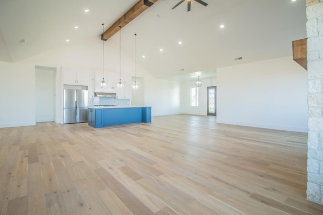 unfurnished living room with high vaulted ceiling, light wood-type flooring, ceiling fan with notable chandelier, and beam ceiling