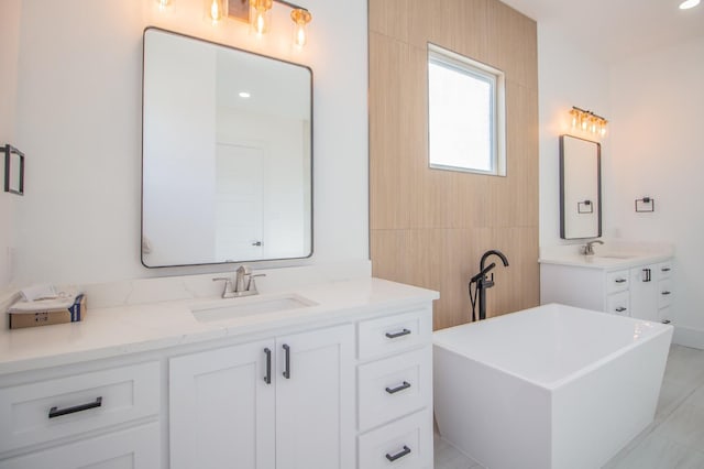 bathroom with vanity and a tub