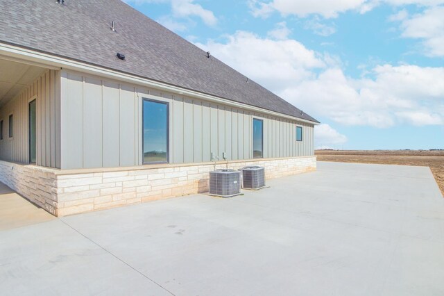 view of side of home with cooling unit and a patio area