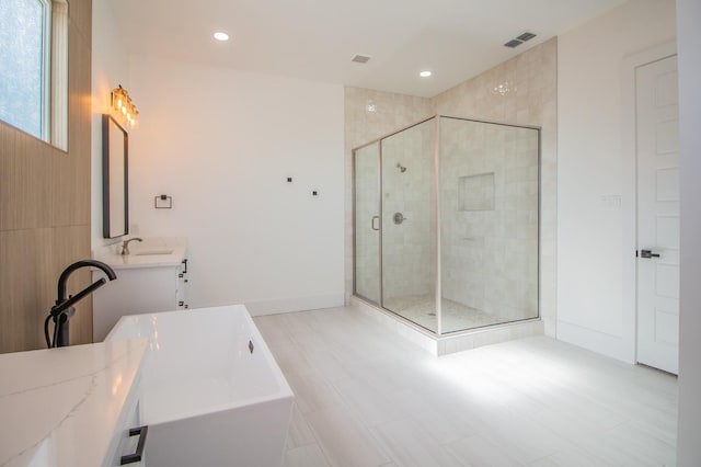 bathroom with plus walk in shower and vanity