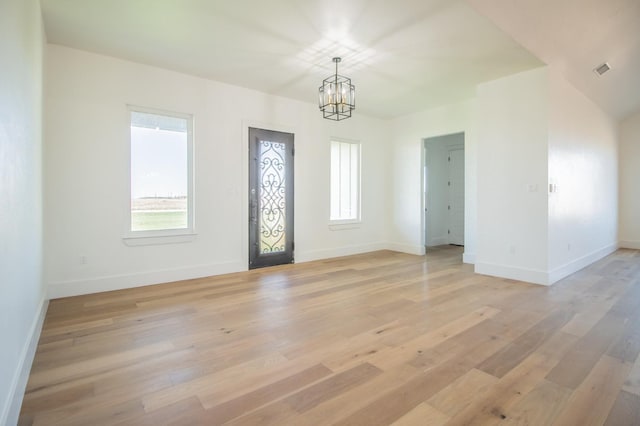 entrance foyer featuring a notable chandelier and light hardwood / wood-style floors