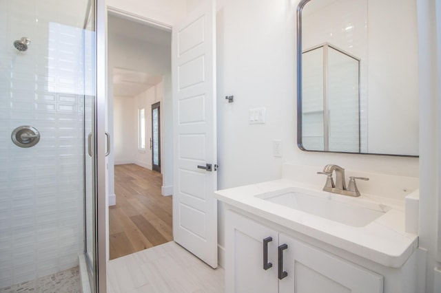 bathroom featuring vanity and a shower with shower door