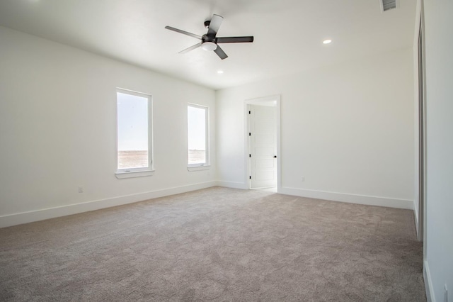 spare room featuring ceiling fan and carpet