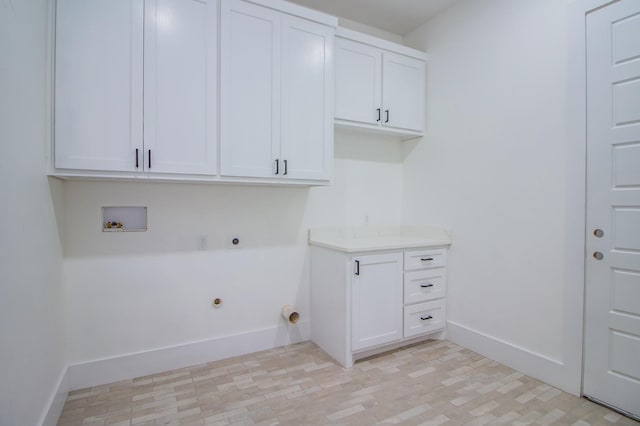 clothes washing area featuring washer hookup, electric dryer hookup, and cabinets