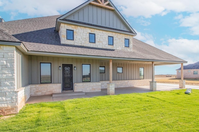 craftsman-style home featuring covered porch and a front yard