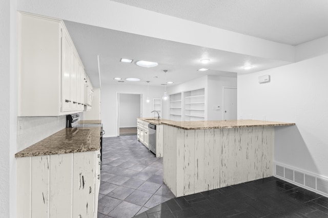 4635 30th St, Lubbock, TX 79410 - kitchen featuring stainless steel dishwasher, white cabinets, dark stone counters, white microwave, and range with electric cooktop